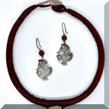 J142. Leather choker with embedded shell and pair of silver drop dragon earrings with brown bead - $38 